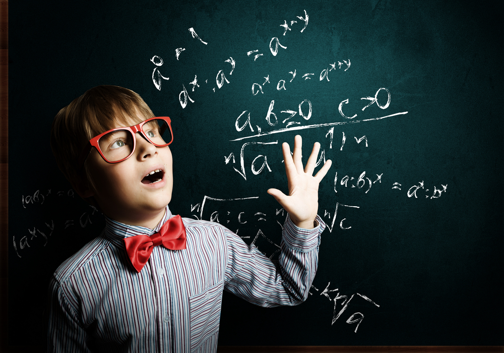Child Genius boy in red glasses near blackboard - why some parents got upset at the latest series of child genius