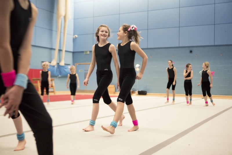 8 Reasons To Join The Display Squad - gymnastics class showing 2 girls walking side by side